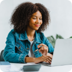 A woman uses her laptop to shop for insurance online. 